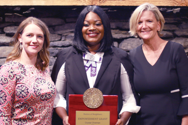Photo of Amy Jones with Crystal Chatman holding award with Darcy Smith