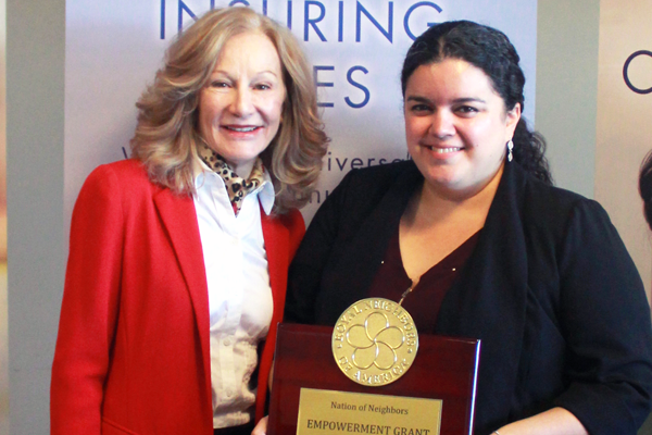 Photo of Cynthia Tidwell with Zenaida Landeros and award