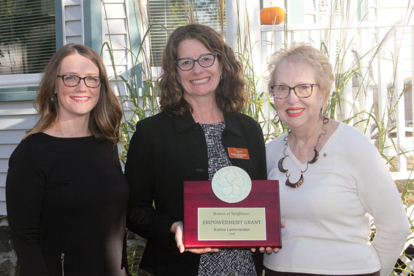 Photo of Amy Jones with Karina Lamorandier holding award with Ginger Smietana