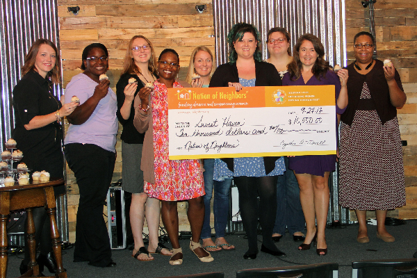 Photo of Amy Jones, Joy Shaffer, Shelly Averette, Antoinette Johnson, Becca March; Olivia Smithberger, Mary Irwin, Beth Cross, and Jeanette Jordan with big check