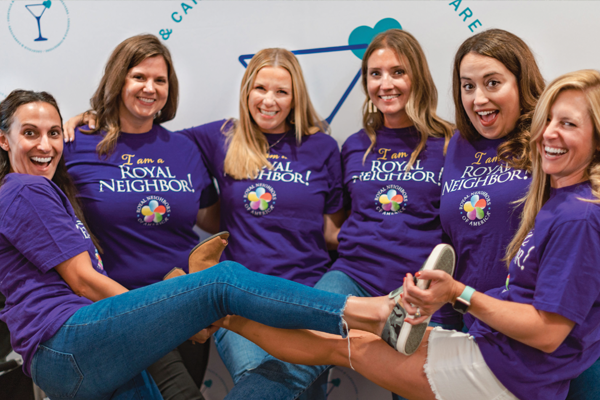 Photo of six cheerful women in I Am a Royal Neighbor purple t-shirts.