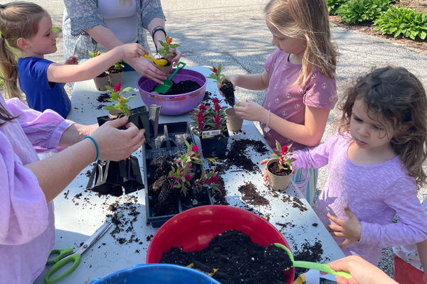 photo of Photo of children with plants making May Day Baskets
