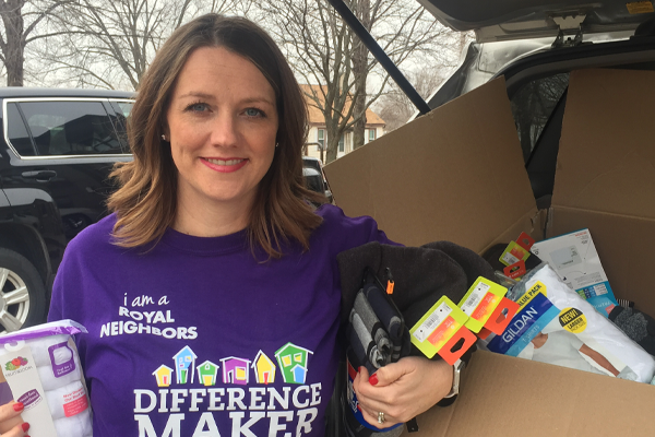 photo of Photo of Amy Jones holding underwear and sock donations.