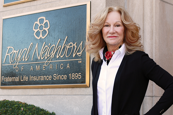 Photo of Cynthia Tidwell in front of Royal Neighbors Home Office