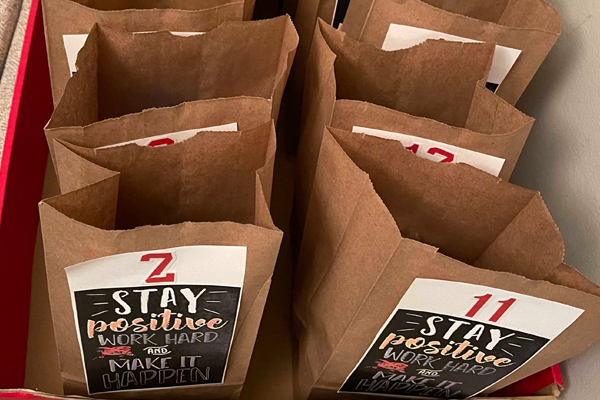 photo of Photo of brown paper bags with positive words.