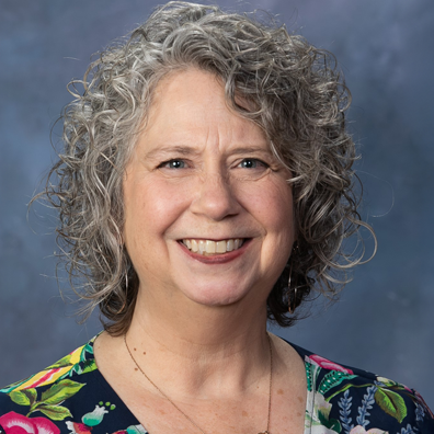 photo of Smiling woman with floral blouse.