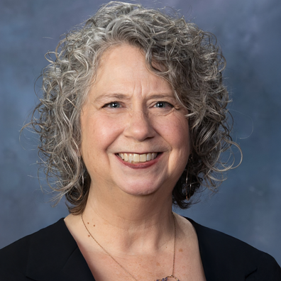 photo of Photo of smiling woman with black blazer.