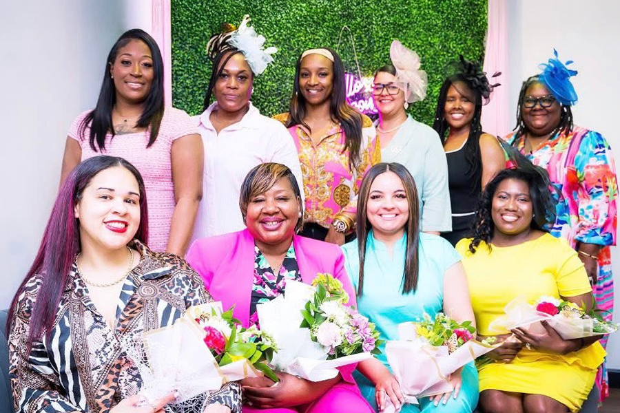 Group of happy women in colorful outfits.