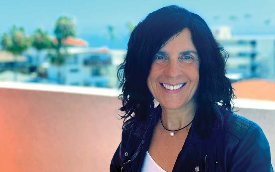 Bea Boccalandro on a beach-view balcony.