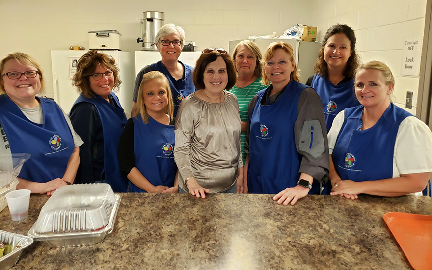 Chapter members serving a meal at a local shelter