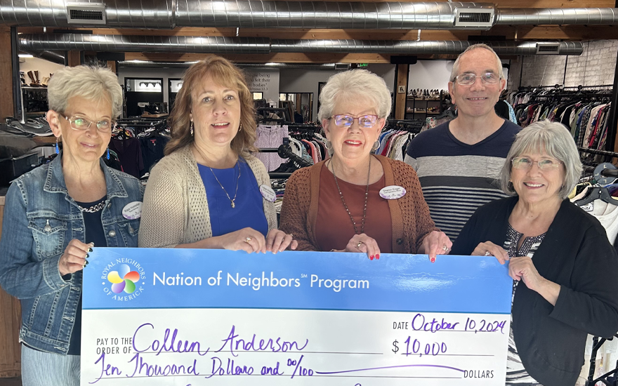 Group of happy people holding a giant $10,000 check.