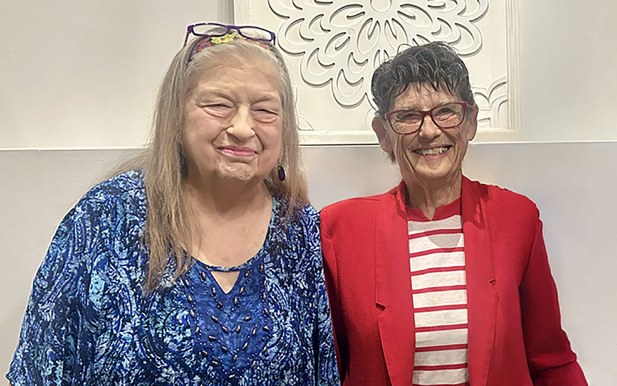 Two happy woman smiling together.
