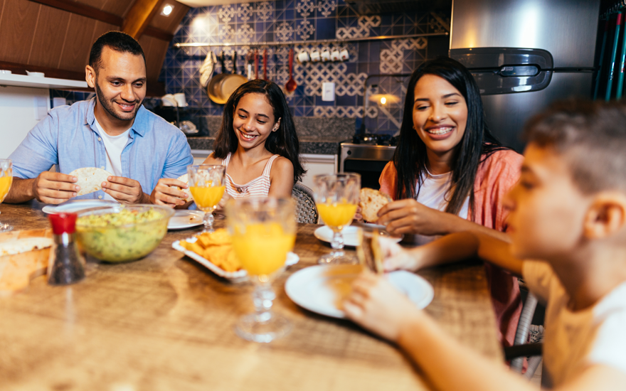 Happy family dinner, father, daughter, mother, and son.