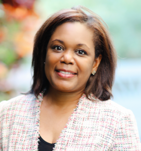 Smiling woman with a colorful background.