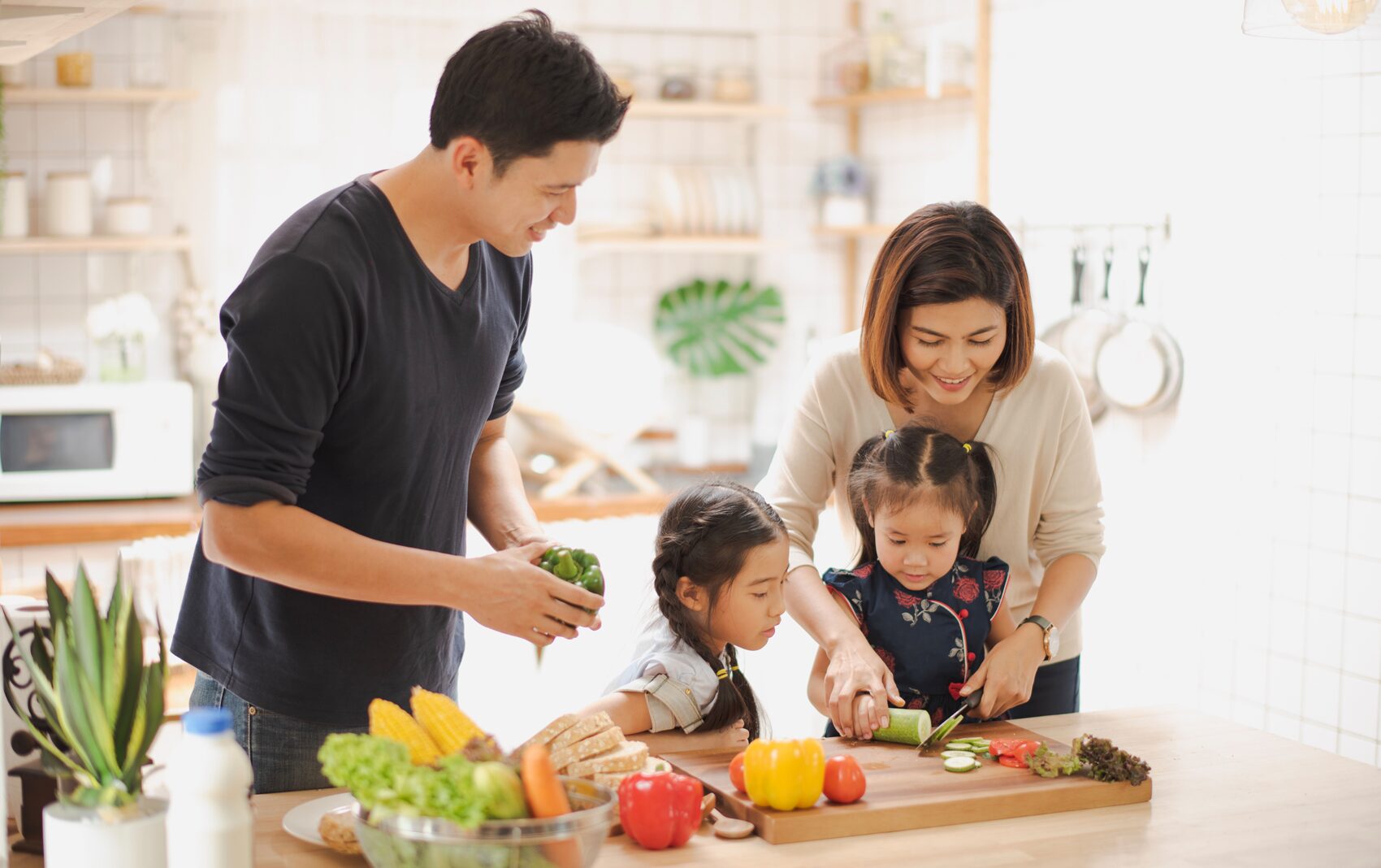 Happy family preparing vegetables in a kitchen.