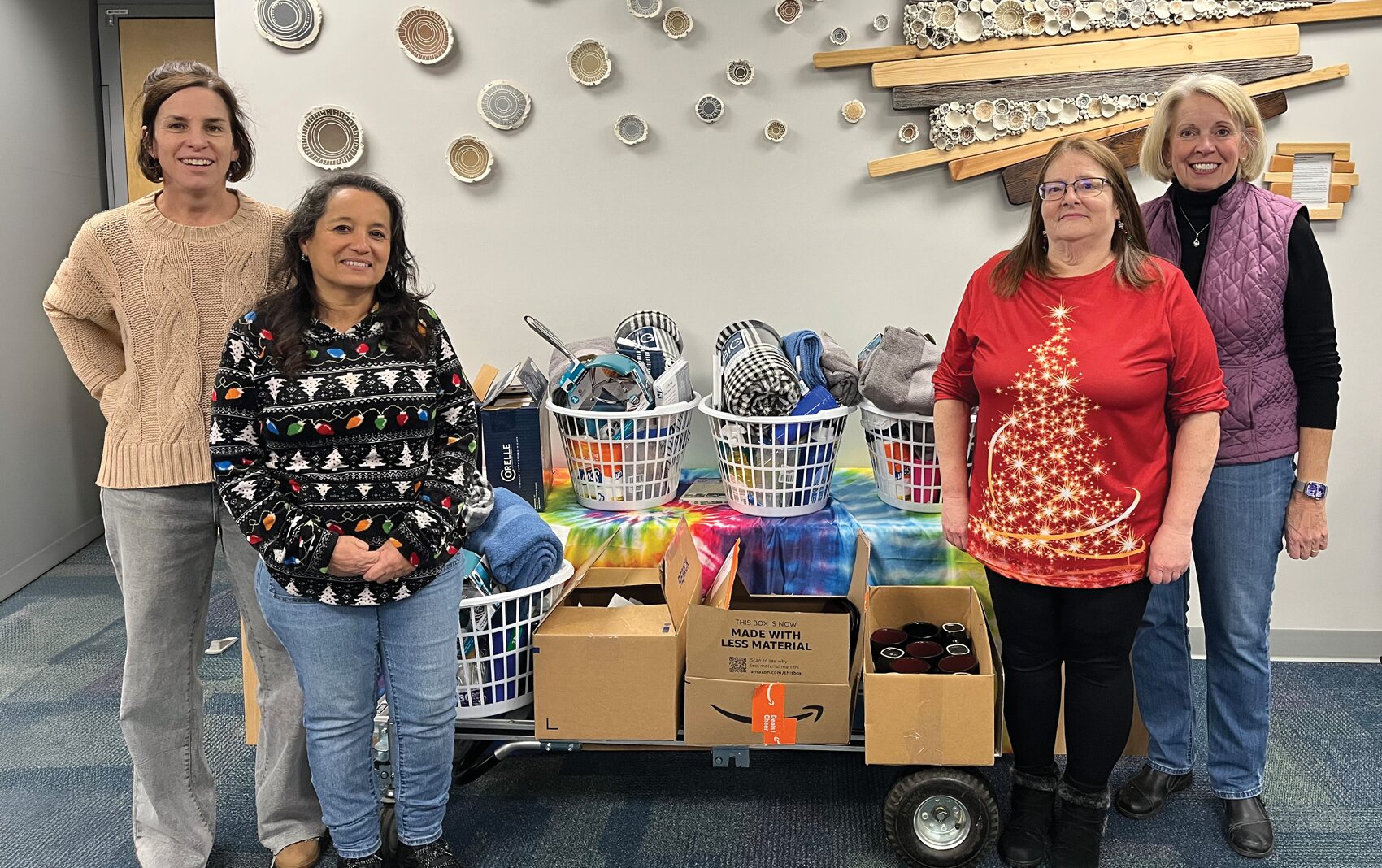 Four happy women with baskets and items in the center.